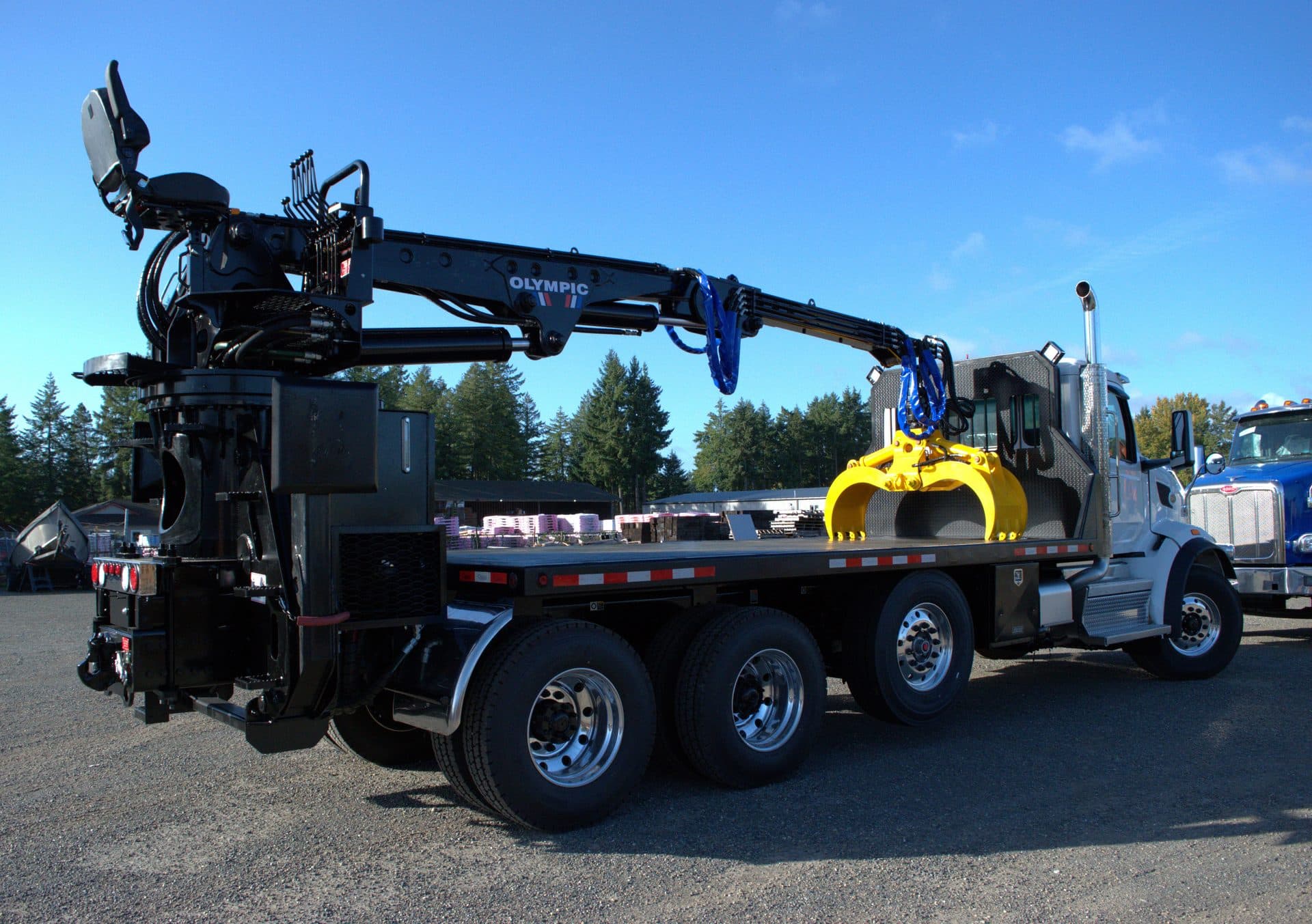 Olympic loader on flatbed truck — any truck, any load